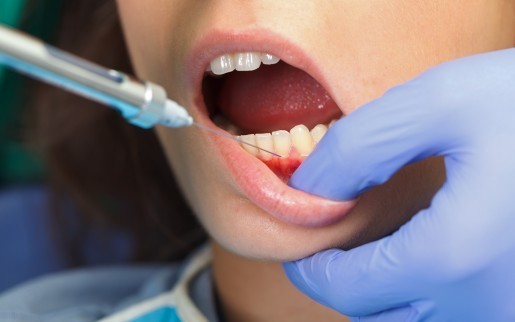 New York dentist applying anesthesia