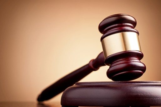 brown gavel on the table on a brown background