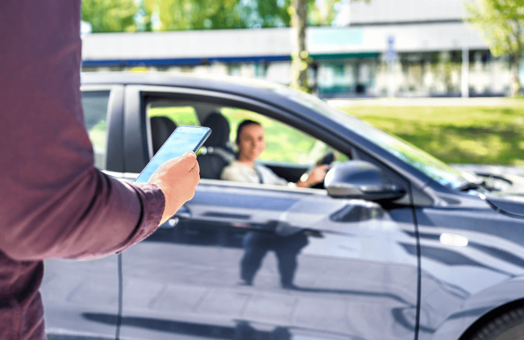 man being picked up by a rideshare vehicle