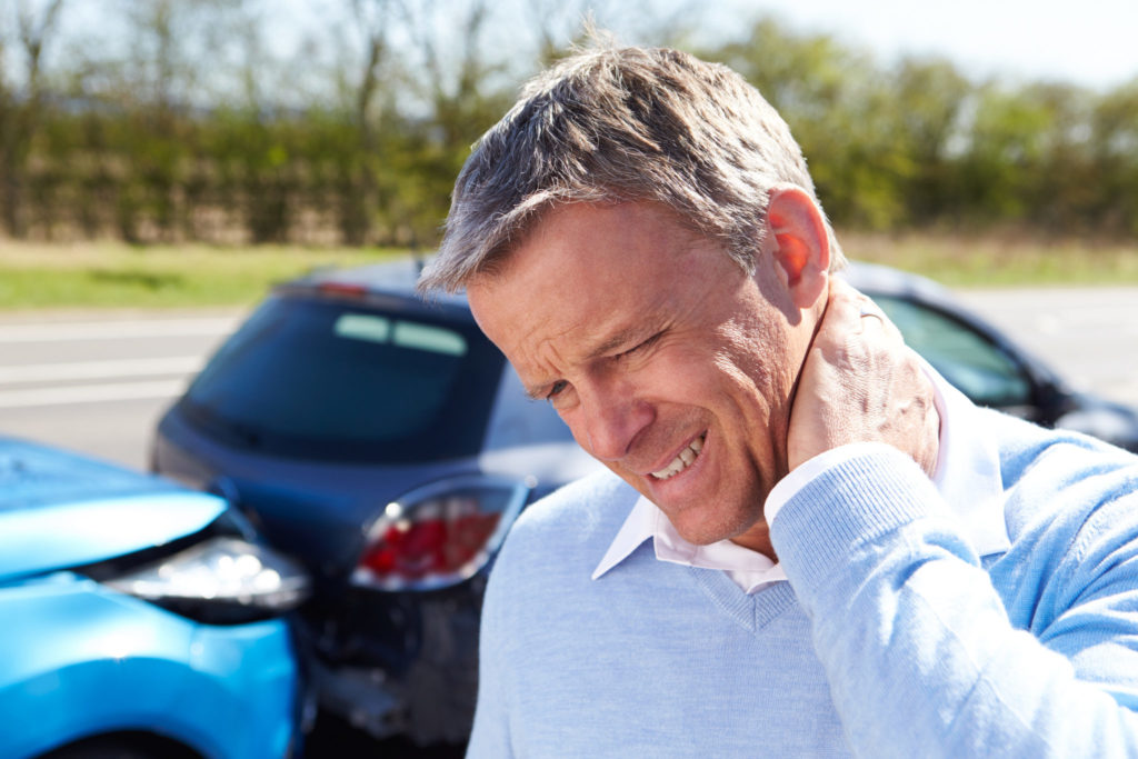 man with injured neck caused by whiplash